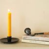 black vintage candle stand and candle snuffer